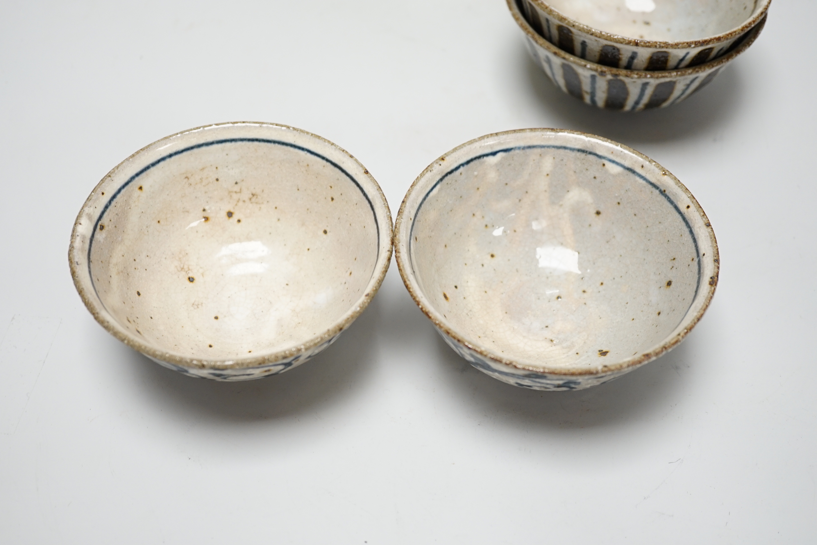 Two pairs of Japanese studio pottery bowls, a European studio bowl and similar ceramic mask raised on hexagonal base, the largest 33cm high